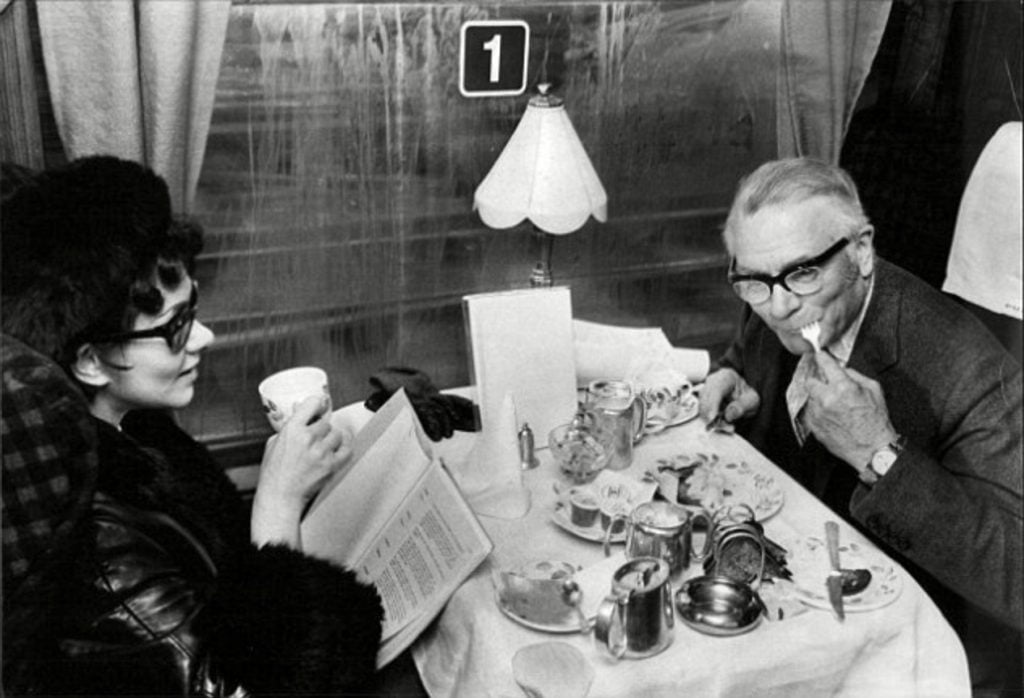 Wider shot of Laurence Olivier and the scrambled eggs, revealing his wife Joan Plowright