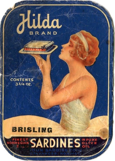 Hilda brand with 20s temptress Hilda holding up an open tin of sardines